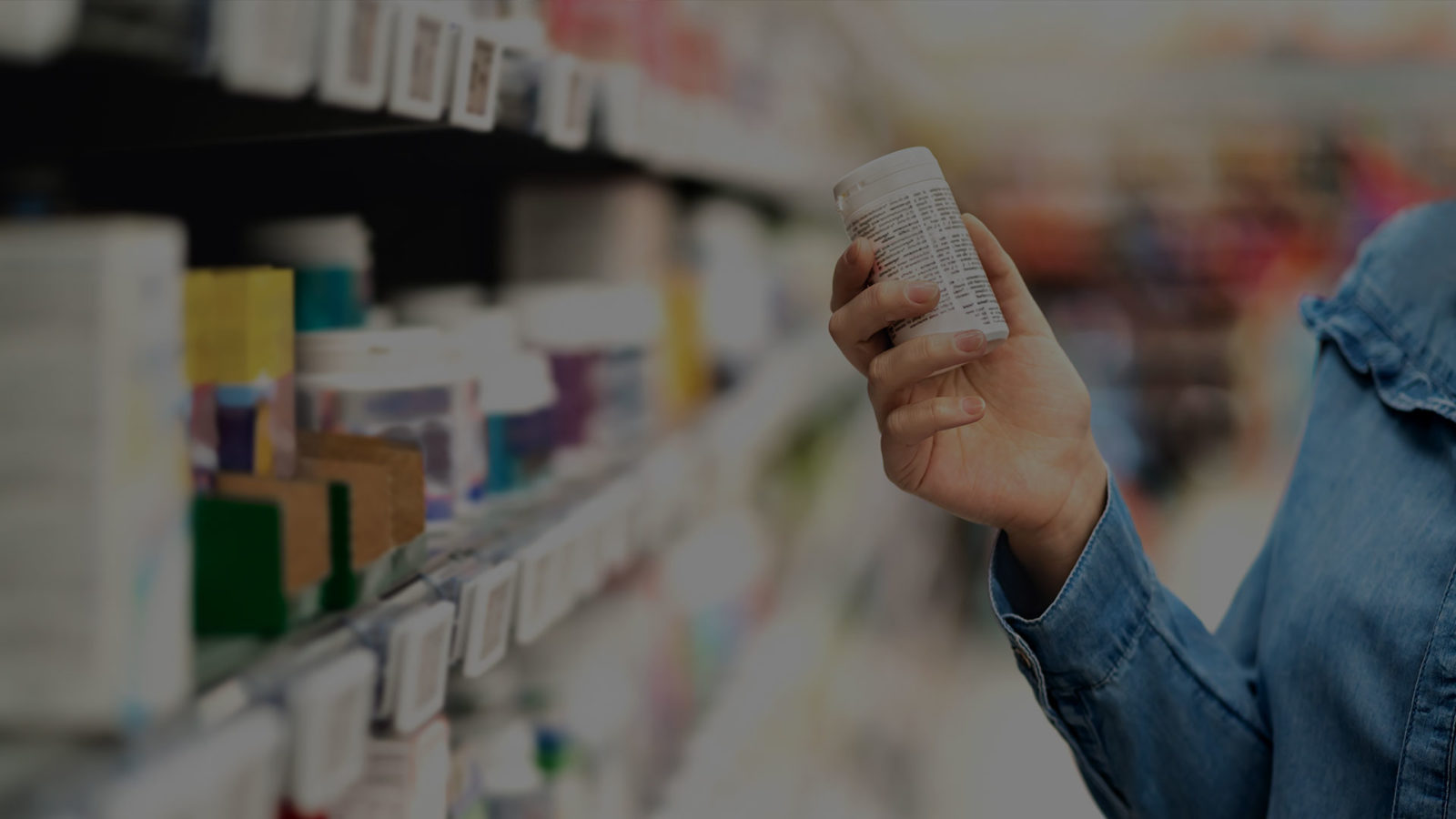 woman by row of products in a shop