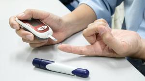 Man performing a diabetes blood test